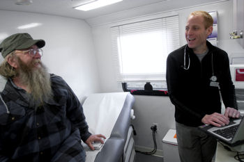 Wayne Centrone MD medical director of outreach for Outside In a social service agency in Portland Ore counsels Tim McCarthy in a mobile medical clinic near Dignity Village a village for the homeless