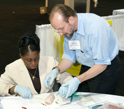 Auguste H Fortin FACP teaches suturing at the Herbert S Waxman Clinical Skills Center