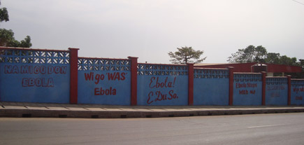 Slogans are painted on walls that face roads to raise awareness for drivers and pedestrians about Ebola in Freetown Sierra Leone Africa Photo by Milagro Gessler RN