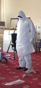 Volunteer medical staff underwent training through the World Health Organization in Freetown Sierra Leone Africa At left a trainer demonstrates WHO standard-protocol personal protective equipment 