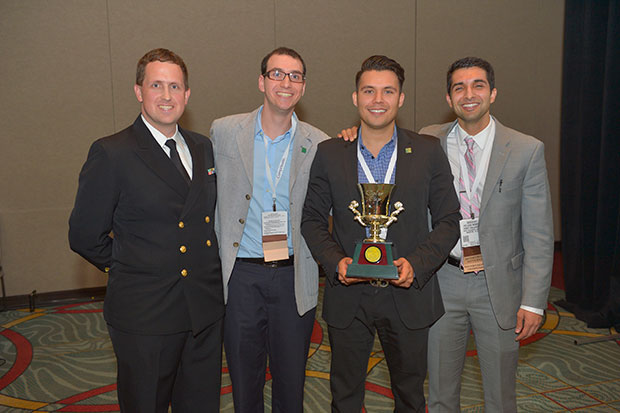 Lt Cmdr Brent Wallace Lacey, MD, FACP (left) presents the ACP's Doctor's Dilemma® trophy to (from left to right) Giovanni Ernesto Davogustto, MD, Raymundo Alain Quintana Quezada, MD, and Uday Gajjan