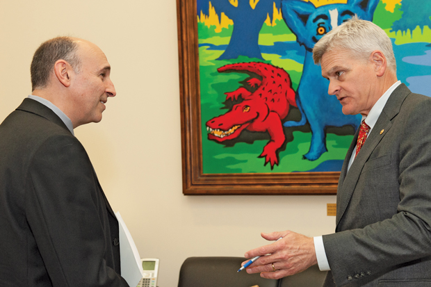 At left ACP Louisiana Chapter Gov Lee Engel MD PhD FACP chats with Sen Bill Cassidy MD R-LA under an alligators watchful eye Photo by James Tkatch